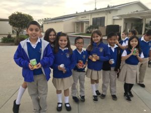 Students hold cans to be donated to Good Sam Pantry during Student Community Day at Beatitudes of Our Lord School in La Mirada.  ANDRE VILLEGAS
