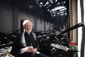 Bishop David O'Connell, auxiliary bishop for the San Gabriel Pastoral Region, visited the damaged mission church the afternoon of Saturday, July 11 and prayed with grieving parishioners. (Victor Alemán/Angelus News)