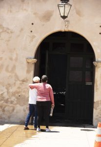 Mission San Gabriel parishioners grieve outside the damaged church's door July 11. (Victor Alemán)