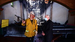Archbishop José H.  Gomez and San Gabriel Fire Chief Steve Wallace inspect the damage to Mission San Gabriel the morning of July 11. (John McCoy/Angelus News)