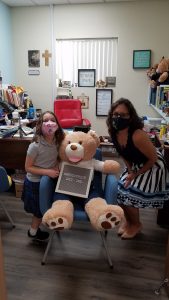 On the first day of school, a second-grader at St. Dorothy School in Glendora stops by to say hello to the principal, Adrienne Ferguson, and visit with Bruno, the school mascot.
(JACLYN CHIDESTER)