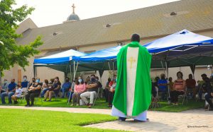 Associate Pastor Fr. José Maria Ortiz celebrates Mass on Sunday, Sept. 13 outside St. Columbkille in South LA. (David Amador Rivera)