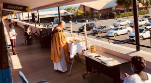 Msgr. Sabato Pilato celebrates a drive-in Mass from the second-story breezeway of St. Anthony of Padua School in Gardena. (Courtesy Msgr. Sabato Pilato)