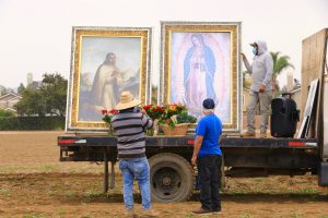 Farmworkers place flowers and produce before the pilgrim images of Our Lady of Guadalupe and St. Juan Diego at the 89th annual procession and Mass Oct. 22. (David Amador Rivera/Angelus News)