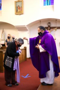 Fr. Domingos Machado, O.A.R., distributes ashes at Cristo Rey Church in Atwater Village Feb. 17. (David Amador Rivera) 