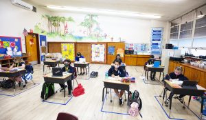 First graders at Holy Name of Mary follow a lesson from teacher Maria Bartelt in one of the school’s first grade classrooms with 10 students. (Victor Alemán)
