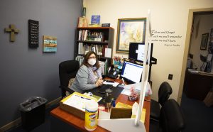 Holy Name of Mary School principal Debbie Marquez added a Plexiglass barrier to her desk as part of the school's COVID-19 safety protocols. (Victor Alemán)
