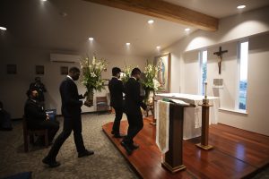 Seminarians from the Queen of Angels Center bring flowers to the newly blessed altar. (Victor Alemán)