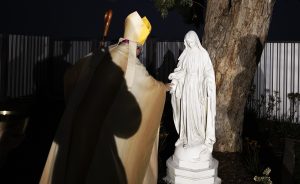 Archbishop Gomez blesses a statue of Mary on the grounds of the Queen of Angels Center. (Victor Alemán)