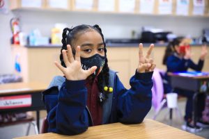 A kindergartener shows her answer in the classroom at St. Bernard School. (David Amador Rivera)