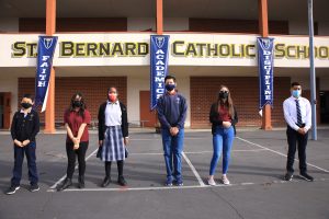 Students stand outside St. Bernard School on the first day of in-person learning. (David Amador Rivera)