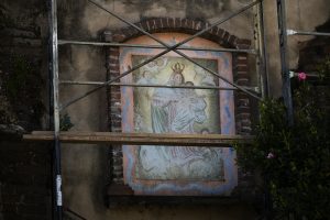 Artwork at San Gabriel Mission is seen behind scaffolding as the mission undergoes renovations following last summer’s fire. (Victor Alemán)