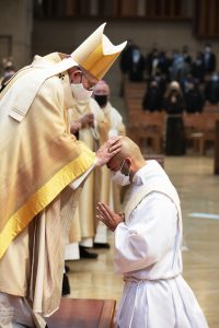 Archbishop José H. Gomez imposes hands on Father Francis Kim during the Rite of Ordination. (Victor Alemán)