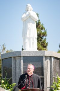 Bishop Robert Barron stands in front of a statue of St. John Vianney, the patron saint of priests. (JohnMichael Filippone)