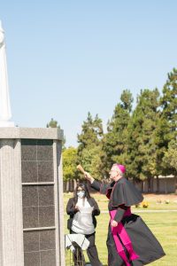 Bishop Barron blesses the new statue of St. John Vianney at Santa Clara Cemetery. (JohnMichael Filippone)