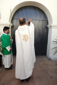 Rev. Arturo Corral-Nevarez, pastor, blesses the Holy Doors at Our Lady Queen of Angels (La Placita) Church. (David Amador)
