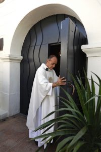 Rev. Arturo Corral-Nevarez opens the doors at Our Lady Queen of Angels (La Placita) Church. (David Amador)