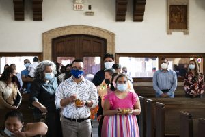 Young people bring up the gifts during the offertory at the 35th annual Mass for members of FUERZA, Inc., at St. Matthias Church in Huntington Park. (Victor Alemán)