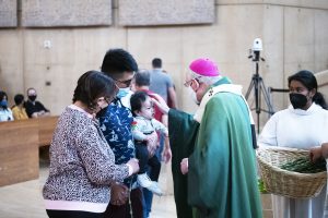 Archbishop Gomez blesses a family at the World Marriage Day Mass. (Victor Alemán)