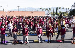 Some 400 students at All Souls World Language School in Alhambra gathered to pray the consecration prayers outside March 25. (Victor Alemán) 