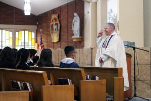 At St. Anthony of Padua School in Gardena, pastor Msgr. Sal Pilato led students in the prayer of consecration sent by Pope Francis to bishops and priests after Communion at the school’s 8 a.m. Mass. (Pablo Kay)