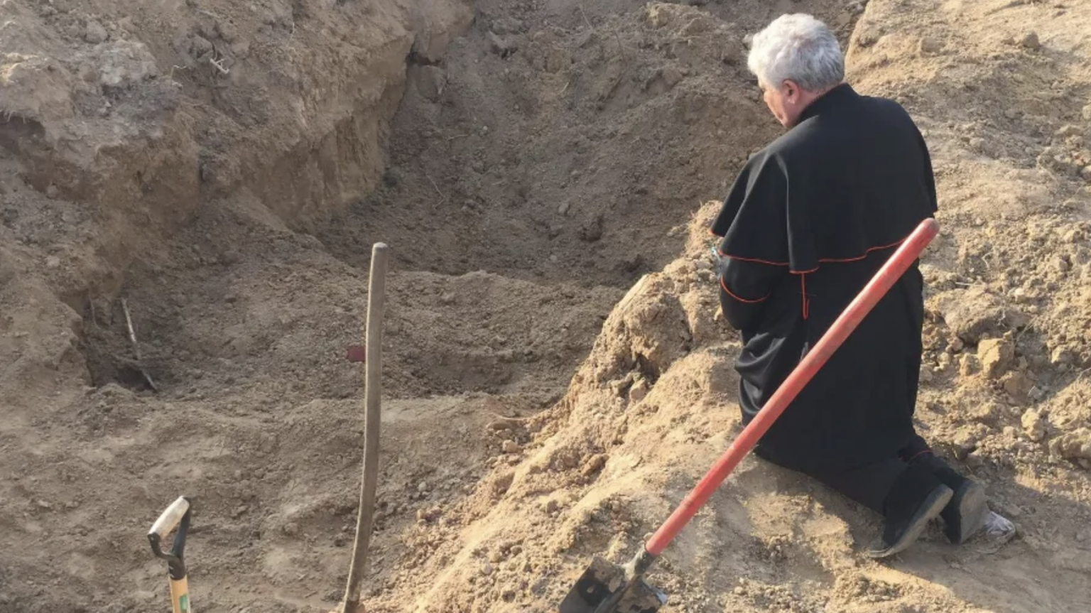 Papal envoy prays at mass grave in Ukraine