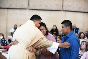 Newly ordained Father Ramon Reyes embraces his sister at the June 4, 2022 Ordination Mass. (Victor Alemán)