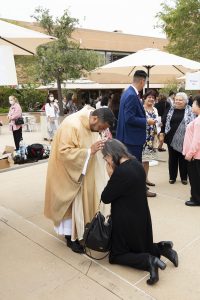 Father Juan Gutierrez gives a first blessing in the Cathedral Plaza after the Ordination Mass. (Victor Alemán)