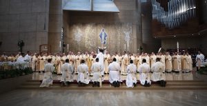 This year’s ordinandi kneel in prayer during the Rite of Ordination. (Victor Alemán)