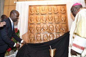 Archbishop John Baptist Odama of Gulu, Uganda and deputy Ugandan Parliament speaker Thomas Tayebwa unveil the altar housing the Ugandan martyrs' relics at St. Genevieve Church in Panorama City on Sunday, June 19. 