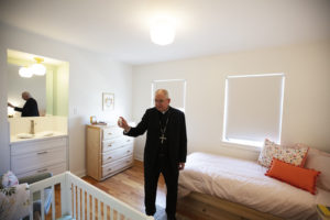 Archbishop José H. Gomez blesses Harvest Home's new Pico Home for homeless pregnant women and their children on Aug. 19. (Victor Alemán)