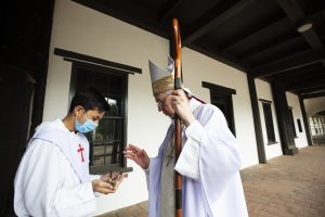 Archbishop Gomez blesses a crucifix at the Mission San Gabriel closing Mass. (Victor Alemán)