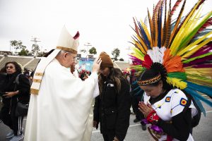 Archbishop Gomez blesses one of the dancers. (Victor Alemán)