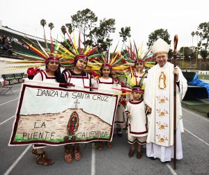 Archbishop Gomez poses with dancers from the Danza la Santa Cruz, who performed at this year's event. (Victor Alemán)