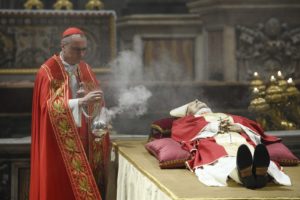 Cardinal Mauro Gambetti, archpriest of St. Peter's Basilica, burns incense at the body of Pope Benedict XVI during a Rite of Reception after the transfer of the body into St. Peter's Basilica in the early morning at the Vatican Jan. 2, 2023. (CNS photo/Vatican Media)