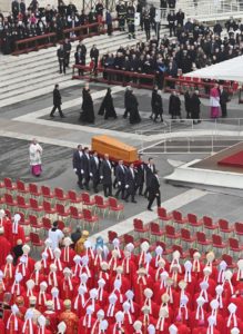 Pallbearers carry a casket with the body of Pope Benedict XVI into St. Peter's Square at the Vatican for his funeral Mass celebrated by Pope Francis Jan. 5, 2023. (CNS photo/Chris Warde-Jones)