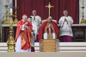 Cardinal Giovanni Battista Re sprinkles holy water on the coffin of Pope Benedict XVI as Pope Francis looks on during the late pope's funeral Mass in St. Peter's Square at the Vatican Jan. 5, 2023. (CNS photo/Vatican Media)