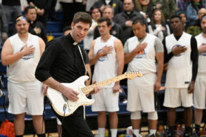 Father Matt Wheeler of Visitation Church in LA played the National Anthem on his electric guitar, then suited up for the Feb. 17, 2023 game. (John McCoy)
