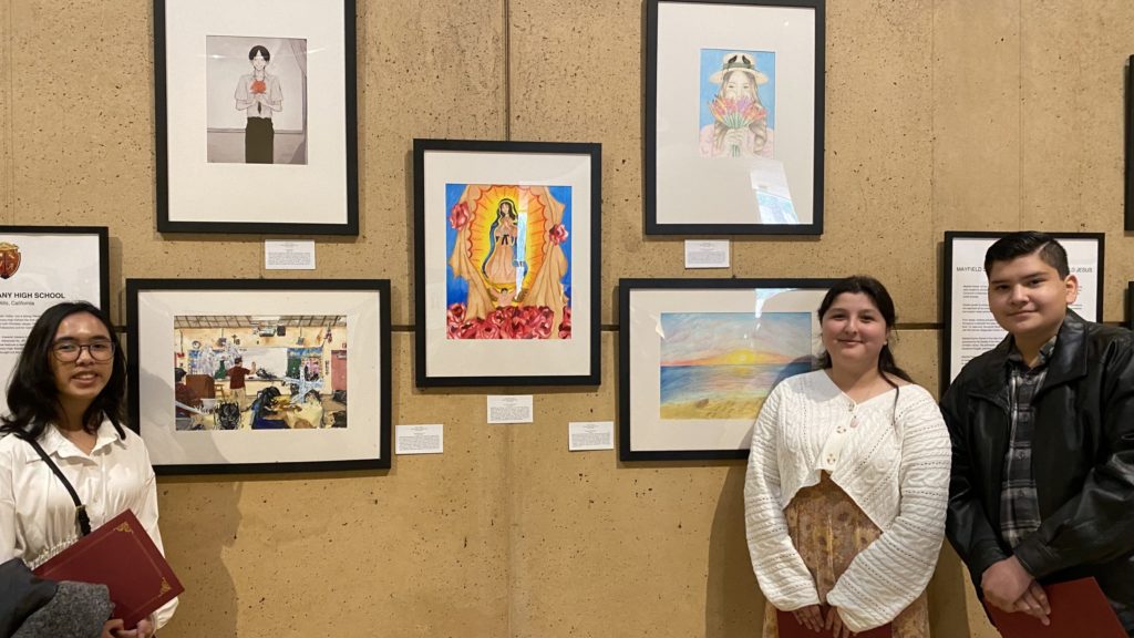 Bishop Alemany students standing in front of their works of art.