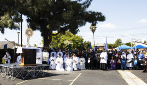 Hundreds of parishioners kneel in adoration of the Blessed Sacrament during the 6-mile eucharistic procession that went from Mission San Gabriel Arcángel to St. Luke the Evangelist Church in Temple City, then back to the mission. (Victor Alemán)