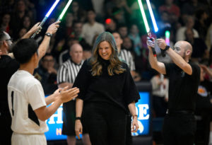 Team Seminarians' coach Libby Reichert enters to a light saber salute at the Feb. 17, 2023, vocations game. (John McCoy)