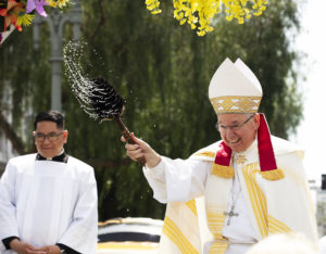 Archbishop José H. Gomez sprinkles holy water for the annual “Blessing of the Animals” on Holy Saturday. (Victor Alemán)