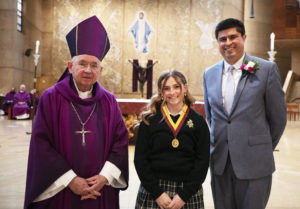 Hayley Christopher of La Reina High School in Thousand Oaks poses with Archbishop Jose H. Gomez and LA Catholic Schools superintendent Paul Escala after being honored at the annual Christian Service Awards Mass at the Cathedral of Our Lady of the Angels March 25. A total of 69 Catholic high school students and 10 teachers were honored at the Mass for their “outstanding commitment to Christian service in the community.” (Victor Alemán)