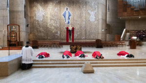 Archbishop José H. Gomez  and concelebrating priests lay prostrate before the cross during the celebration of the passion of the Lord on Good Friday.  (Victor Alemán)