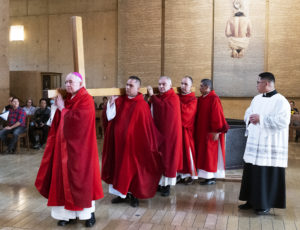 Archbishop José H. Gomez and concelebrating priests carry the cross during the celebration of the passion of the Lord on Good Friday.  (Victor Alemán)