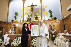 Los Angeles County Supervisor Hilda Solis presents a certificate to Msgr. John Moretta, pastor of Resurrection Church in Boyle Heights, during a special Mass on April 30 celebrating 55 years since his ordination to the priesthood and 40 years at Resurrection. (Victor Alemán)