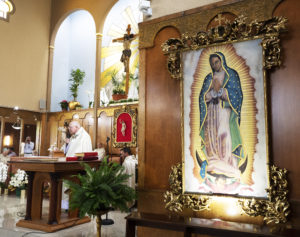 The Blessed Virgin Mary looks on during a special Mass at Resurrection Church in Boyle Heights for Msgr. John Moretta, who was celebrating 55 years since his ordination to the priesthood and 40 years at Resurrection. (Victor Alemán)