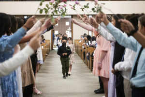Students at St. Dorothy School in Glendora process under an arch of flowers during a May 5 May Crowning Mass. (Victor Alemán)