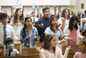 Students at St. Dorothy School in Glendora pray during a May 5 May Crowning Mass. (Victor Alemán)