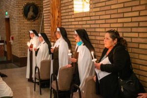 The Carmelite Sisters of the Most Sacred Heart of Los Angeles sing during a special Mass and candlelight procession in response to the Dodgers' decision to honor the Sisters of Perpetual Indulgence on Friday, June 16. (John Rueda/ADLA)